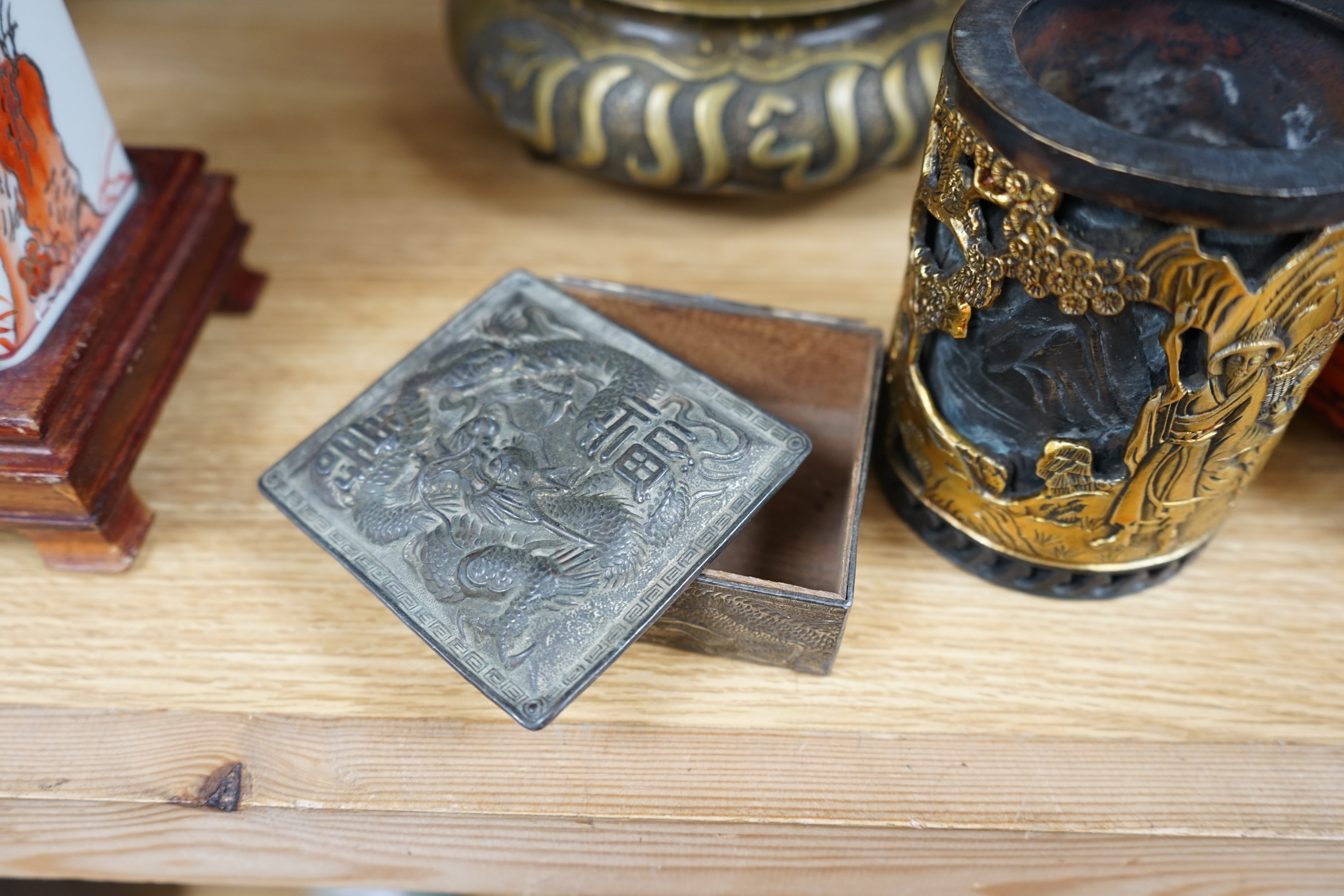 A collection of Chinese and Japanese items to include a lacquered box, a bronze tripod censer, a white metal box and carved seals, largest 25cm wide. Condition - mostly fair